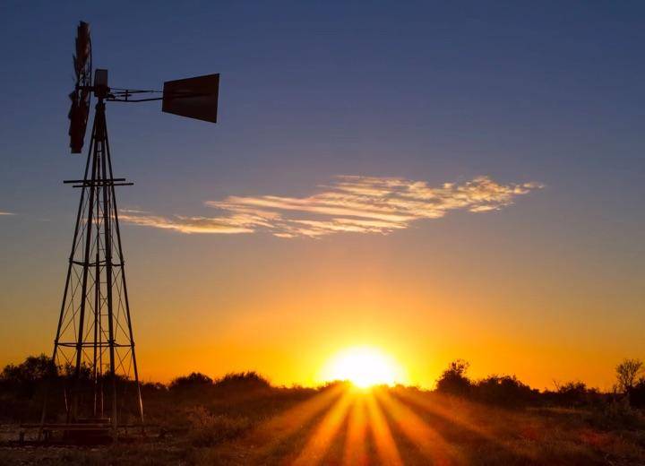 Outback setting with windmill in foreground.